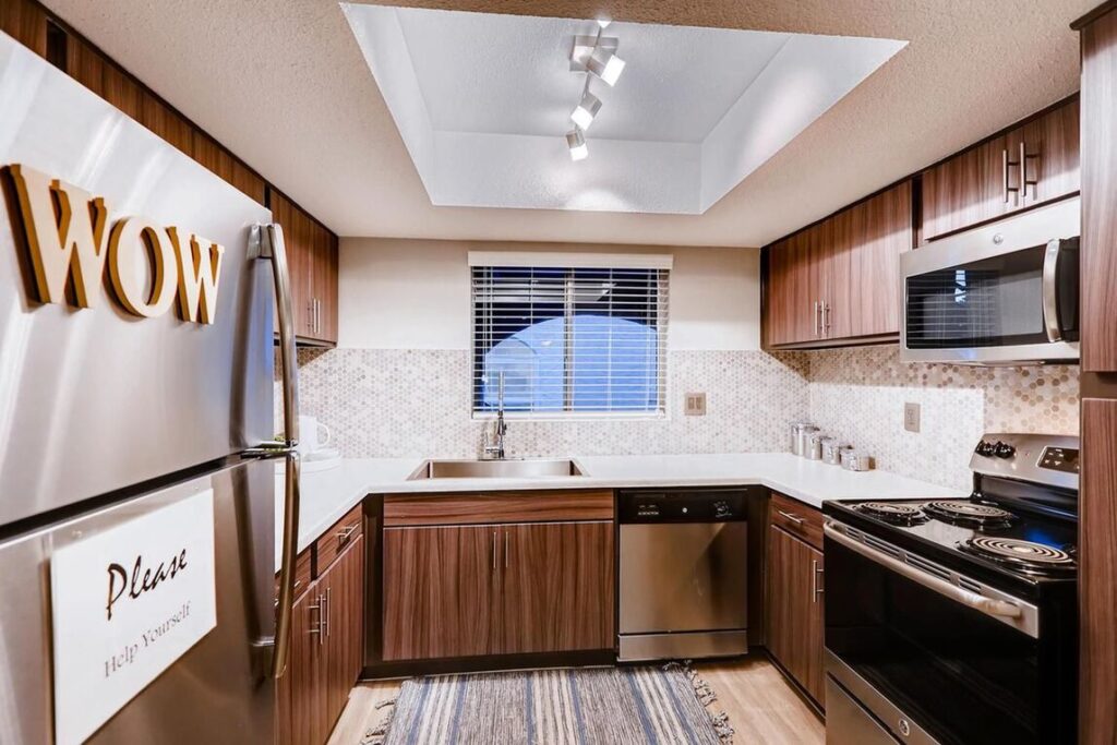 Kitchen with stainless steel appliances and white counters