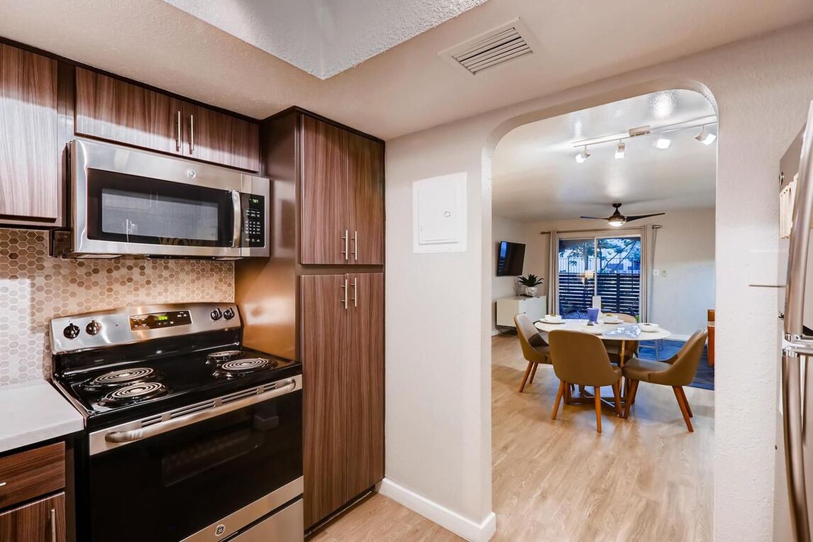 Kitchen with stainless steel appliances and white counters