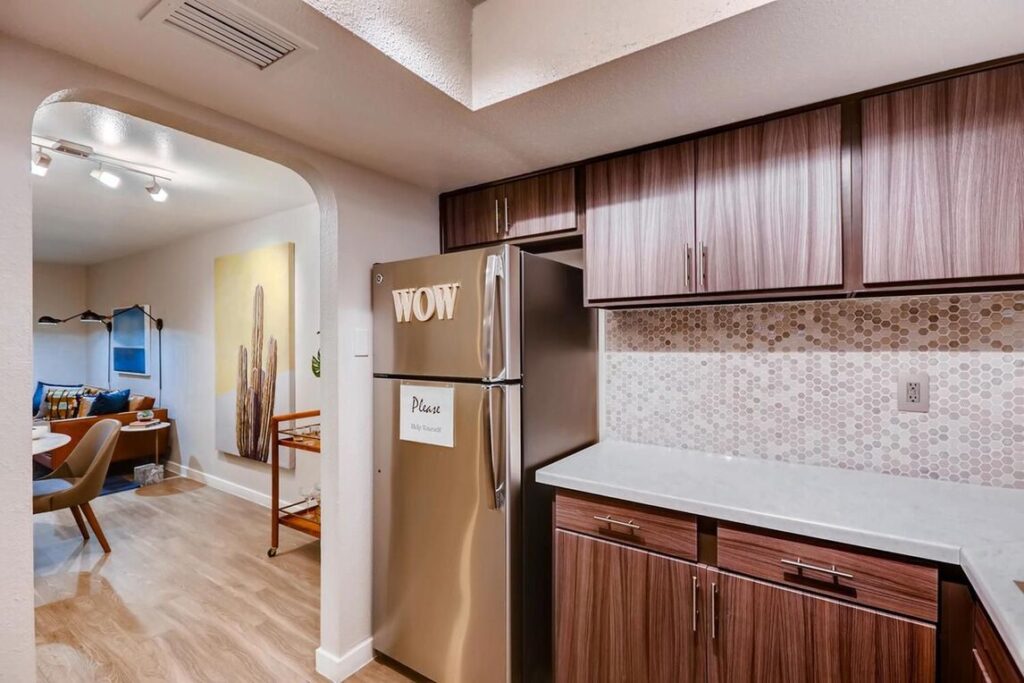 Kitchen with stainless steel appliances and white counters