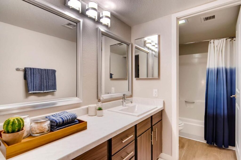 Bathroom with double mirror and separate toilet and shower area