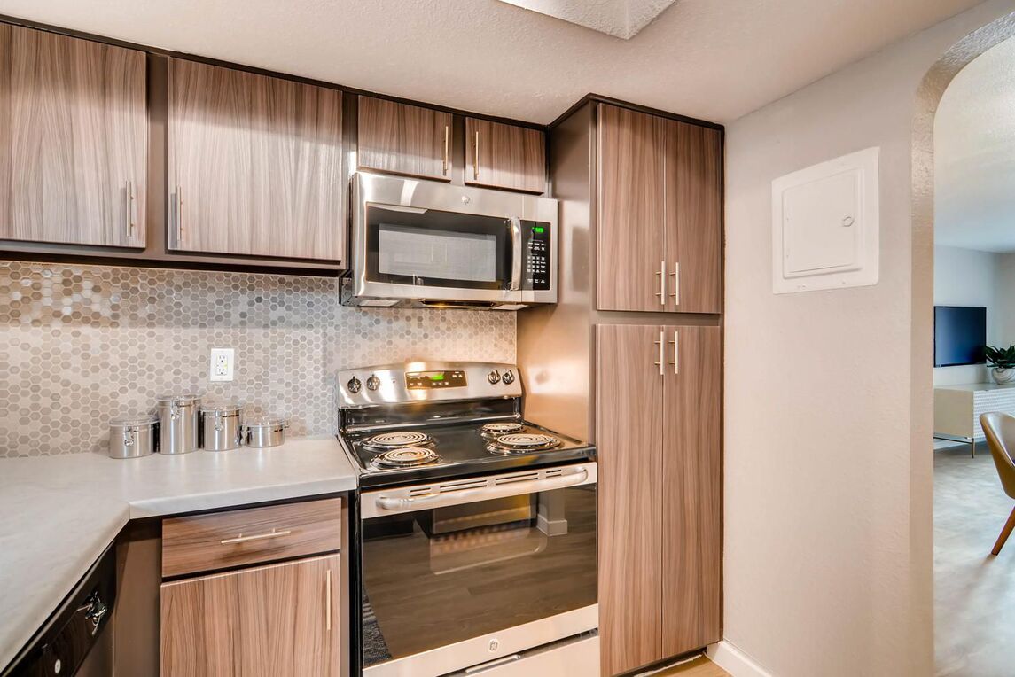 Kitchen with white counters and stainless steel appliances