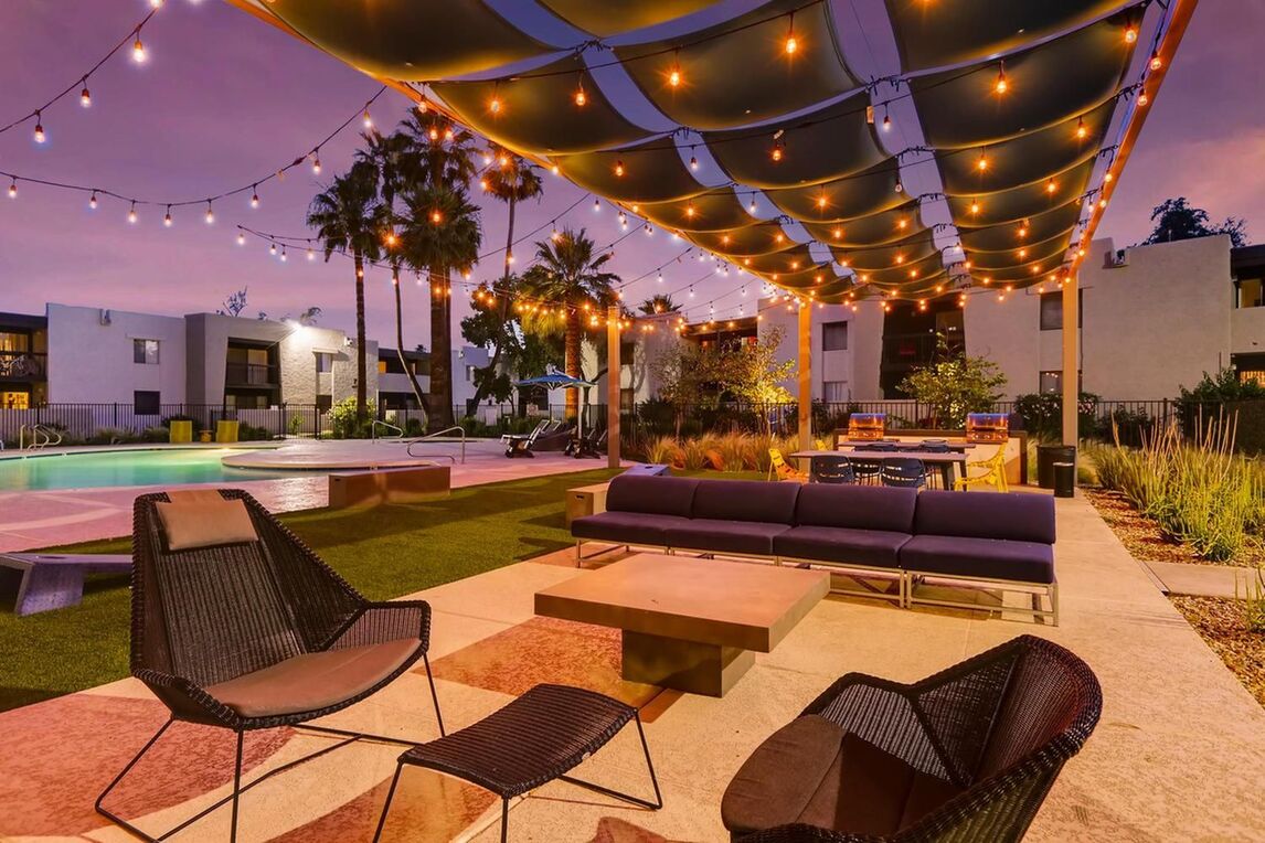 Pool area with shaded pool deck and outdoor furniture